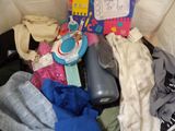 a suitcase full of clothes and toys on the floor