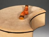 a small orange object on top of a wooden box