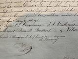 an old document with writing on it sitting on top of a table