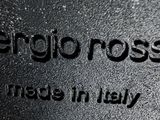 black and white photo of a close up of a sign with the words sergio ross