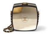 a chanel black and gold clutch bag with chain strap