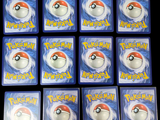 nine pokemon cards on a black table with a black background