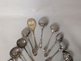 a lot of silver spoons and spoon spoons on the table