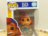 a close up of a pop vinyl figure in a box on a table