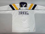 a white hockey jersey with a yellow and black stripe on it