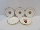 three plates with a coat of arms on them and a plate with a coat of arms on it