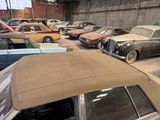 many old cars parked in a garage next to each other