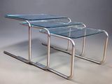 two glass nesting tables with chrome legs and a clear glass top