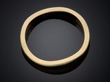 a close up of a gold ring on a black surface