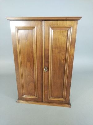 an image of a wooden cabinet with two doors and a door handle