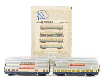 two toy trains sitting next to each other in front of a box