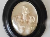 a picture of a man riding a horse in a black frame