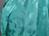 a close up of a woman wearing a green dress