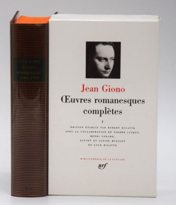 the book is sitting on a table next to a brown book