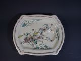 a plate with a floral design on it on a table