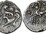 a silver coin with an image of a horse on it