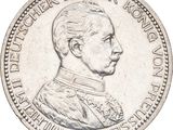 une vieille pièce d'argent sur laquelle figure le portrait d'un homme