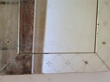 a mirror hanging on the wall in a bathroom
