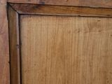a close up of a wooden door with a name tag on it