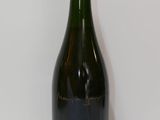 an empty bottle of wine sitting on top of a white table