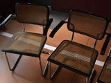 four chairs are lined up in a row on a tiled floor