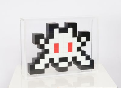 a black and white cube with a red dot on it