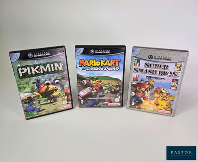 three nintendo wii games sitting on top of a white table