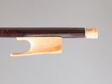 a close up of a violin bow on a gray background