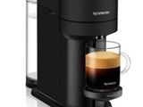 une cafetière noire avec une tasse de café posée devant