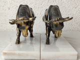 pair of brass bull bookends on marble bases
