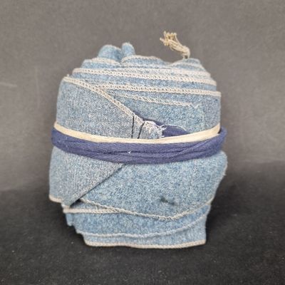 a picture of a roll of blue jeans wrapped in a purple ribbon