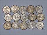 a bunch of coins sitting on top of a white surface