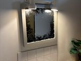 a sink in a small bathroom with a mirror above it