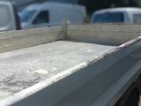 a close up of a truck bed with a lot of trucks in the background