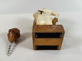a small wooden box with a piece of wood on top of it
