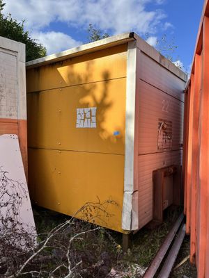 a yellow box sitting in the middle of a yard