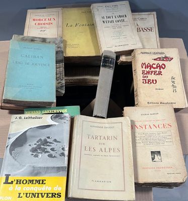 a lot of books that are sitting on top of a table