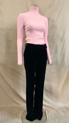 pink turtle neck sweater and black pants on a mannequin base