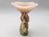 a small vase with a flower on top of it