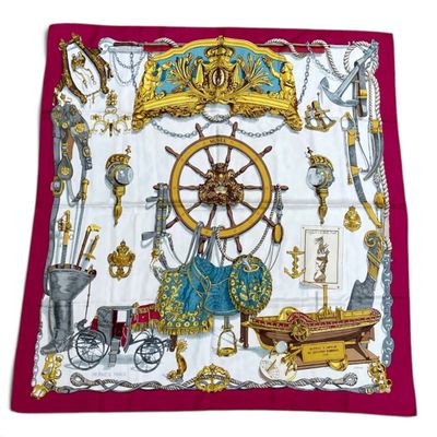 a close up of a square scarf with various items on it