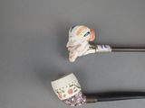 two pipe holders that are sitting next to each other on a table