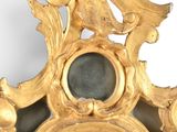 a mirror with a gold frame and a mirror with a bird on it