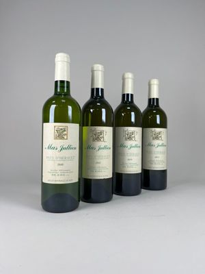 four bottles of wine are lined up on a table