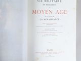 an open book on a white surface with a red and black title