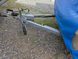 a bike attached to a trailer with a blue cover on it