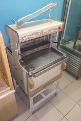 a machine that is sitting in a kitchen next to a refrigerator
