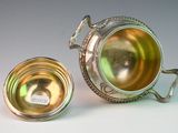 a silver cup and a silver cup on a table