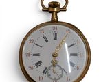 a gold pocket watch with roman numerals on it