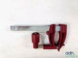a clamp that is attached to a wall next to a piece of metal