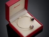 an image of a bracelet in a red box on a black surface